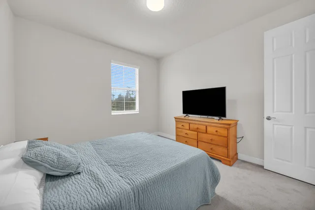 a bedroom with a bed and couch