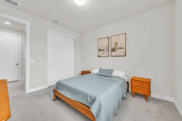 a bathroom with a granite countertop sink a toilet a mirror and shower
