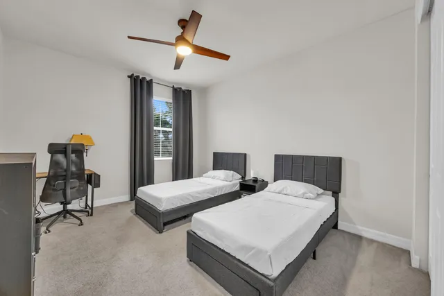 a bedroom with a bed a desk and chair