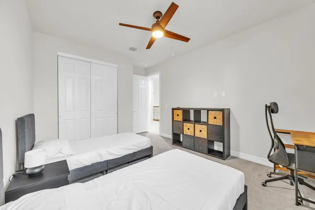 a spacious bedroom with two beds and painted walls