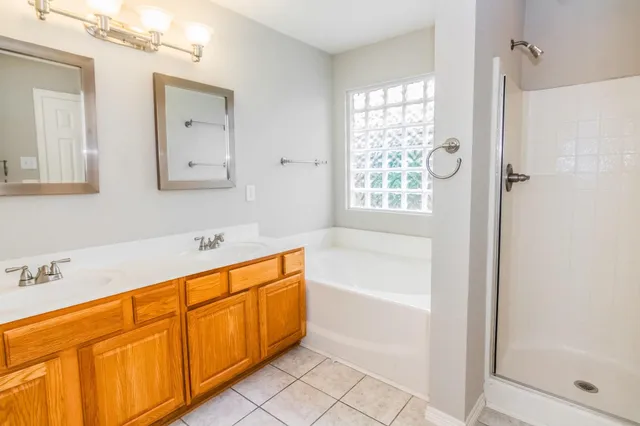 a bathroom with a tub sink and mirror