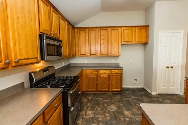 a kitchen with a stove a sink and a microwave