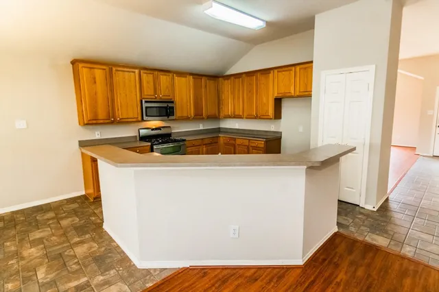 a kitchen with a sink a window and cabinets