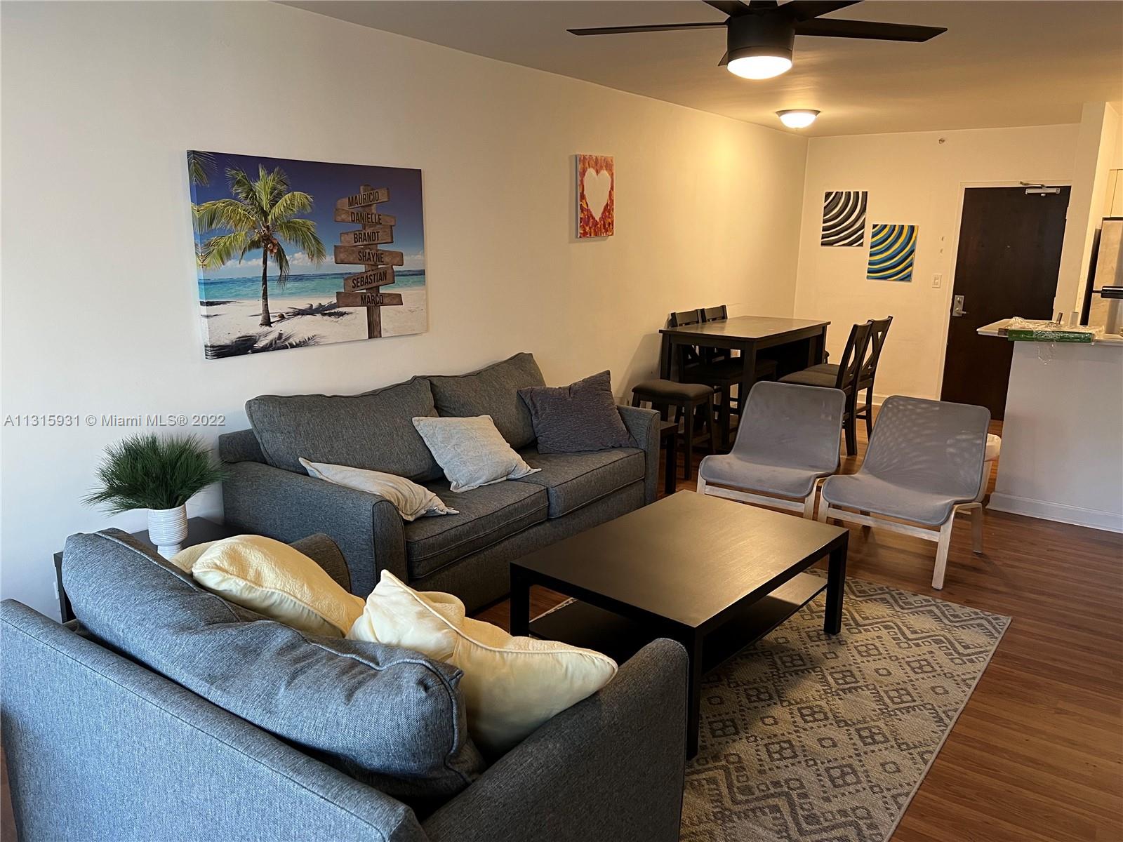 1500 Bay Road, Unit 944S Miami Beach, FL 33139 - Photo 11 of 82 a living room with furniture and a rug