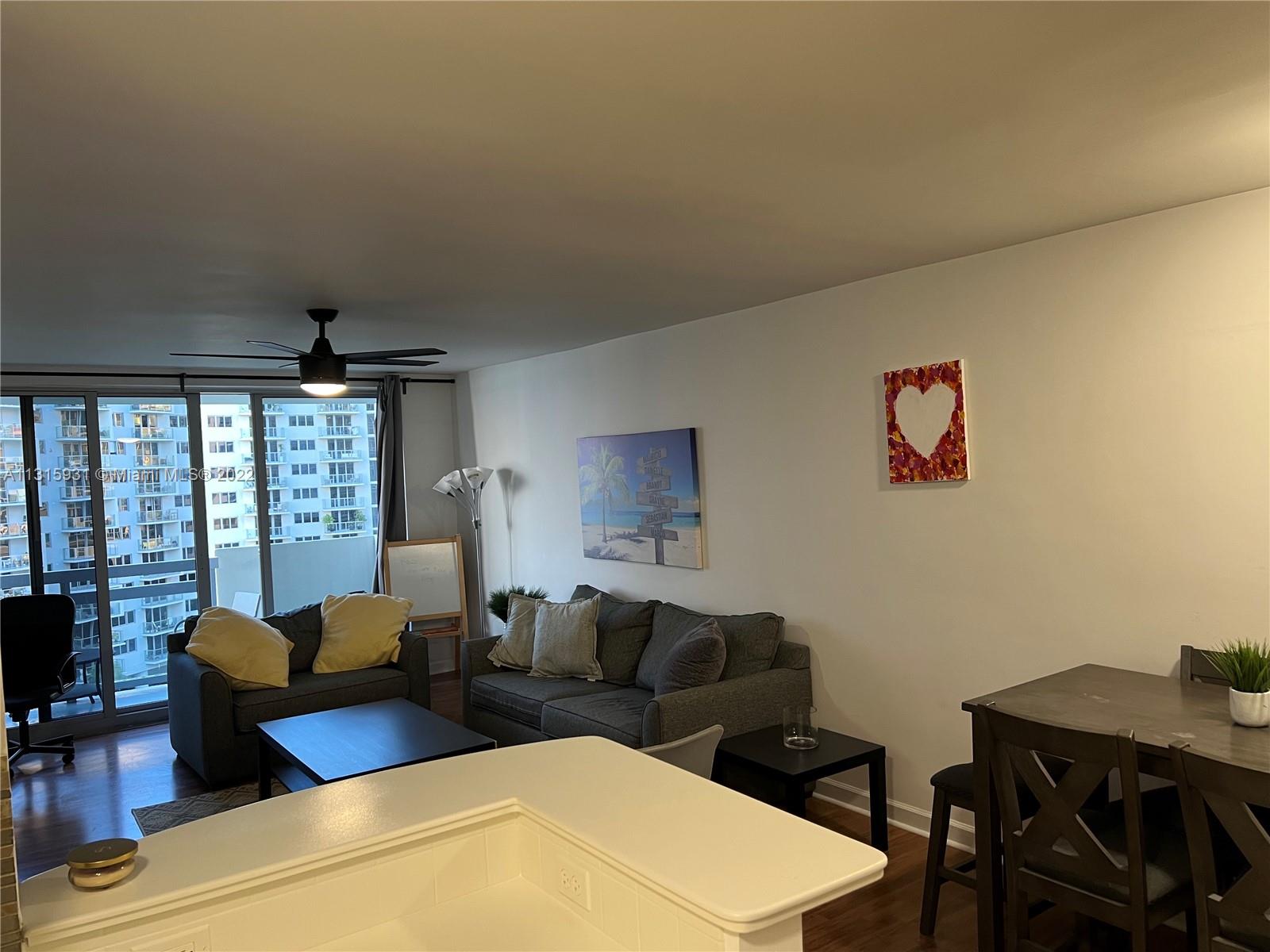 1500 Bay Road, Unit 944S Miami Beach, FL 33139 - Photo 12 of 82 a living room with furniture and a large window