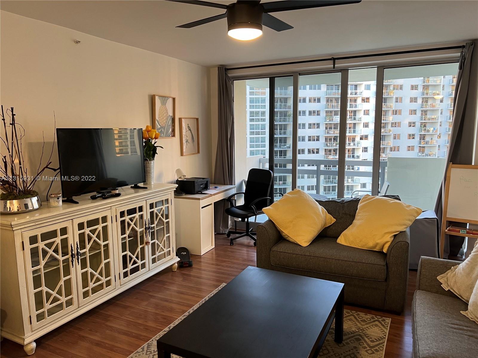 1500 Bay Road, Unit 944S Miami Beach, FL 33139 - Photo 13 of 82 a living room with furniture and a flat screen tv