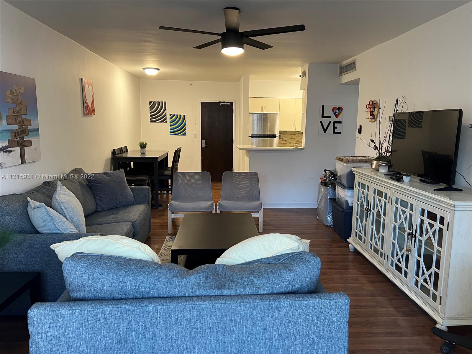 1500 Bay Road, Unit 944S Miami Beach, FL 33139 - Photo 14 of 82 a living room with furniture and a flat screen tv