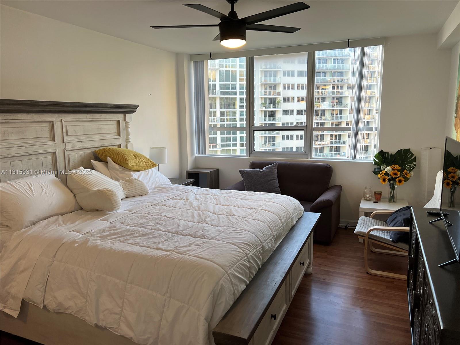 1500 Bay Road, Unit 944S Miami Beach, FL 33139 - Photo 18 of 82 a bedroom with a bed window and couch