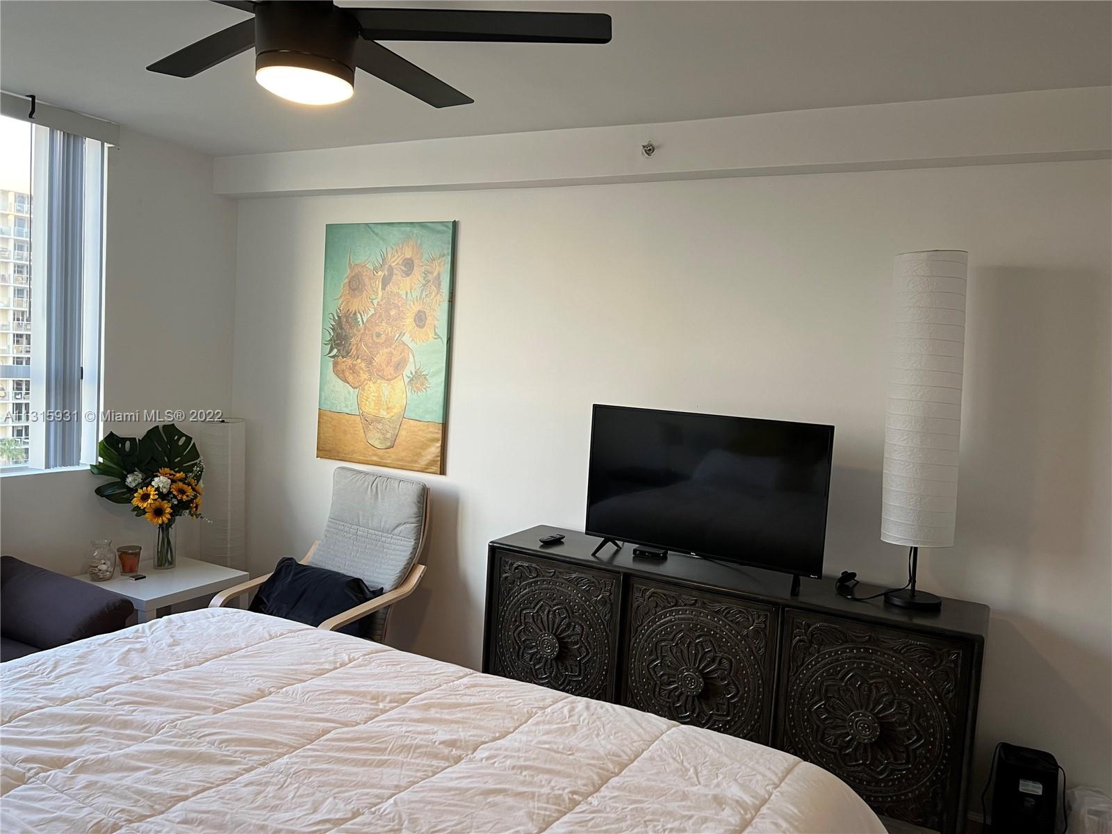 1500 Bay Road, Unit 944S Miami Beach, FL 33139 - Photo 19 of 82 a bedroom with a bed and a flat screen tv
