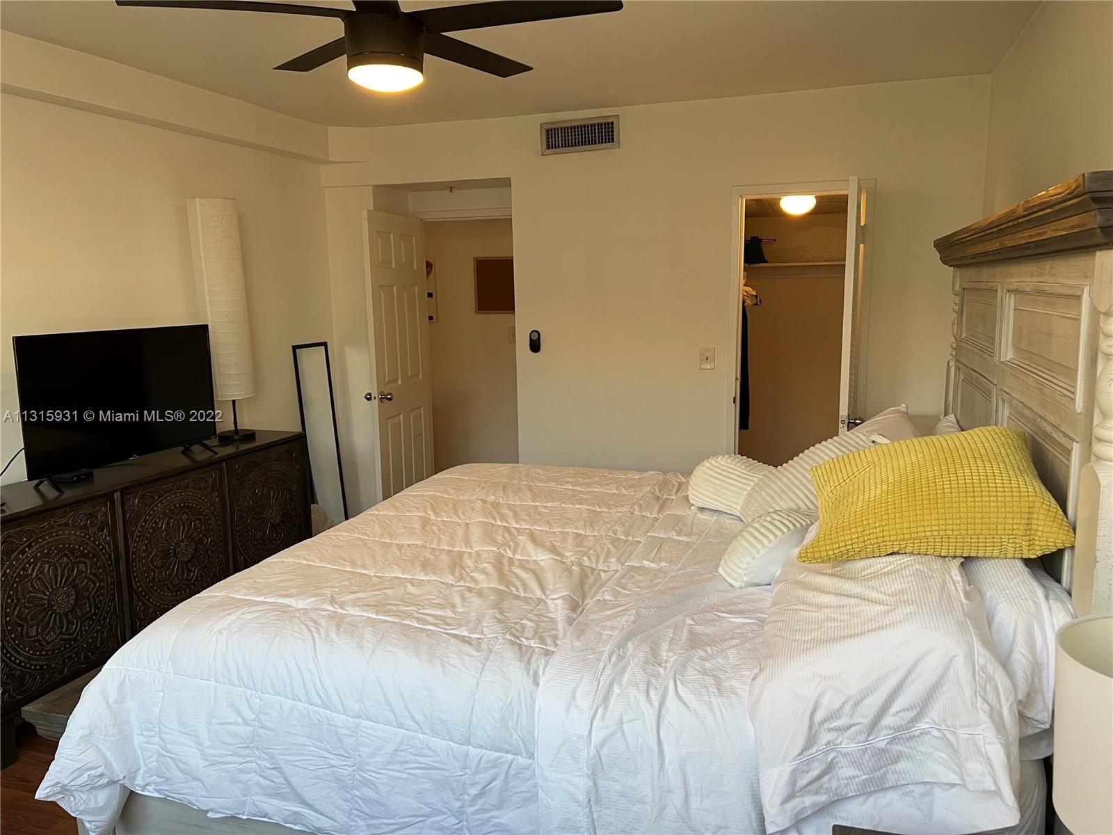 1500 Bay Road, Unit 944S Miami Beach, FL 33139 - Photo 20 of 82 a bedroom with a bed and a flat screen tv