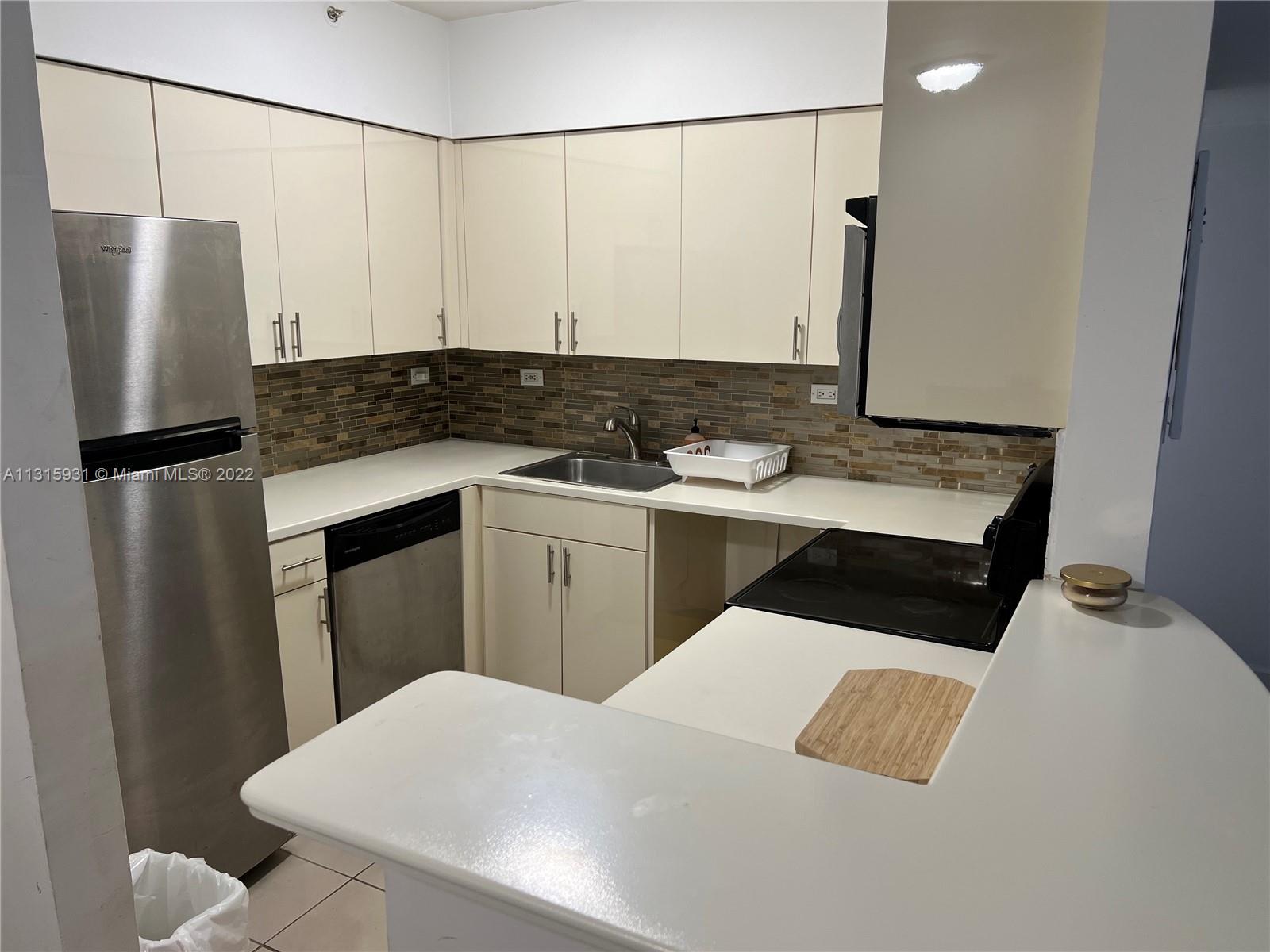 1500 Bay Road, Unit 944S Miami Beach, FL 33139 - Photo 24 of 82 a kitchen with a sink appliances and cabinets