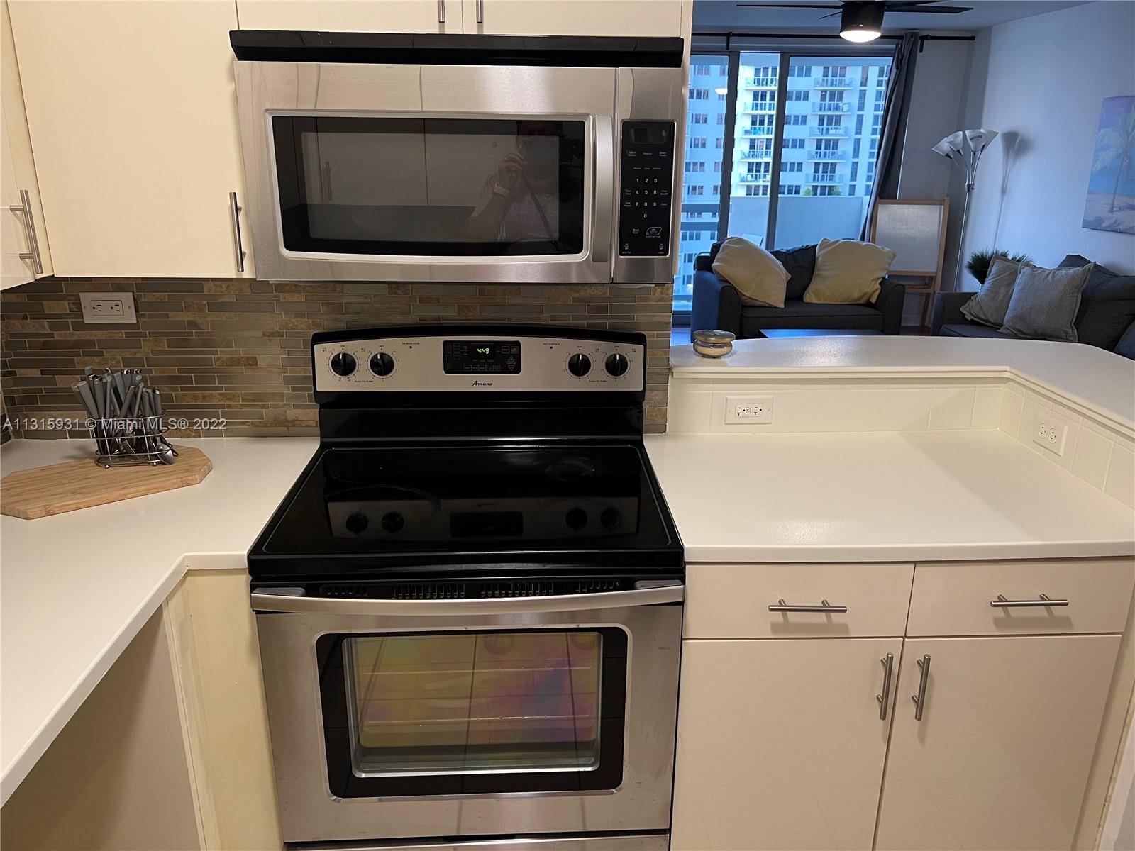 1500 Bay Road, Unit 944S Miami Beach, FL 33139 - Photo 26 of 82 a kitchen with a stove and a microwave