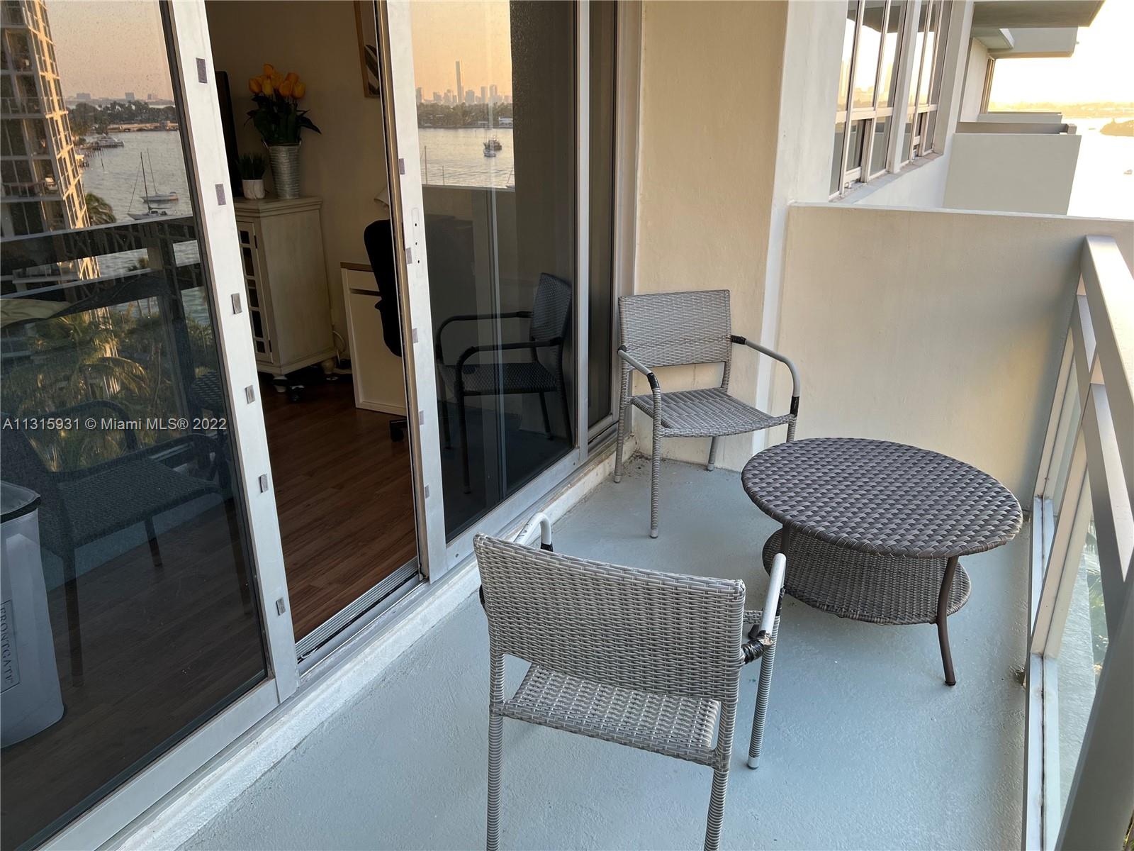 1500 Bay Road, Unit 944S Miami Beach, FL 33139 - Photo 8 of 82 a view of a hallway with chairs and a potted plant on a table