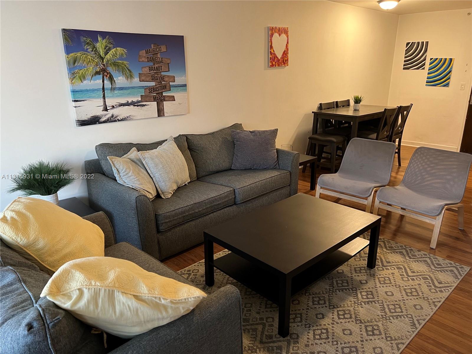 1500 Bay Road, Unit 944S Miami Beach, FL 33139 - Photo 10 of 82 a living room with furniture and a lamp