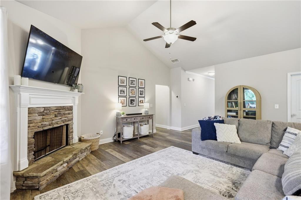 47 Violet Lane Dallas, GA 30132 - Photo 8 of 27 a living room with furniture a flat screen tv and a fireplace