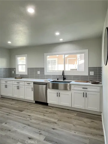 a kitchen with granite countertop white cabinets and white appliances