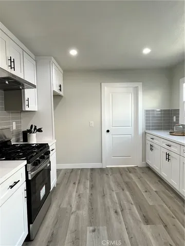 a kitchen with granite countertop a stove and a sink