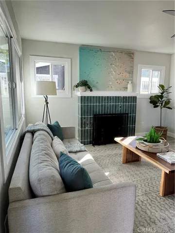a living room with furniture a window and a fireplace