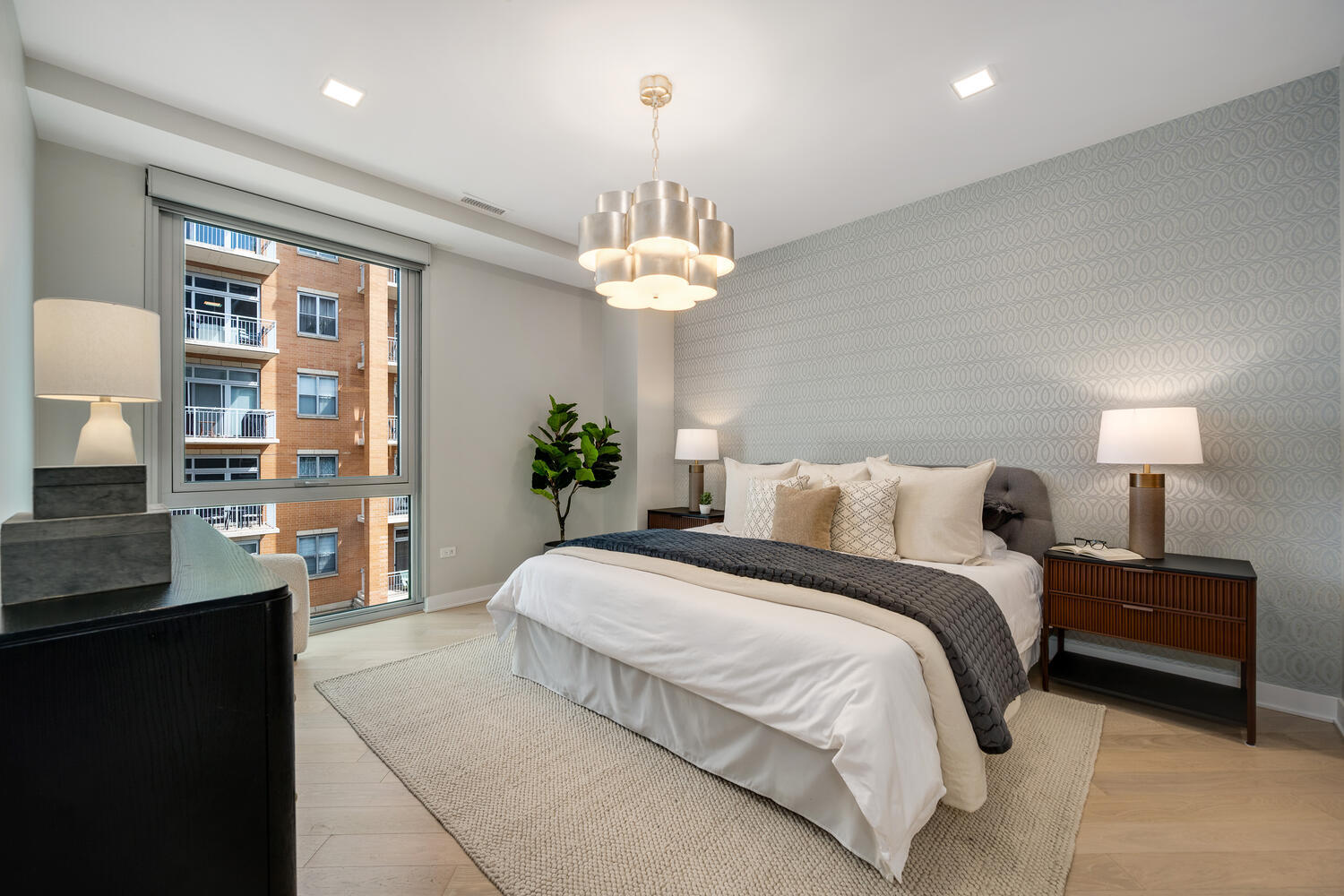 1000 West Monroe Street, Unit 502 Chicago, IL 60607 - Photo 17 of 29 a spacious bedroom with a bed and a chandelier
