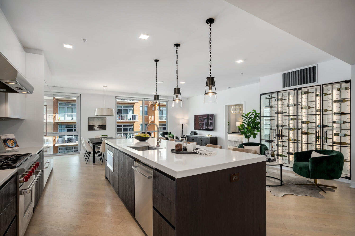 1000 West Monroe Street, Unit 502 Chicago, IL 60607 - Photo 4 of 29 a kitchen with stainless steel appliances kitchen island granite countertop a sink counter top space and a view of living room