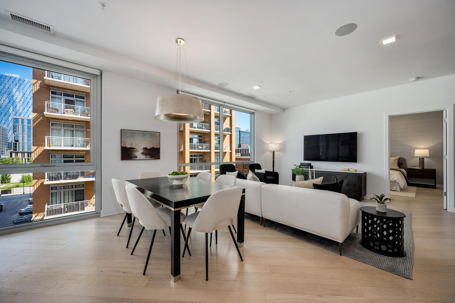 1000 West Monroe Street, Unit 502 Chicago, IL 60607 - Photo 10 of 29 a living room with furniture a flat screen tv and kitchen view