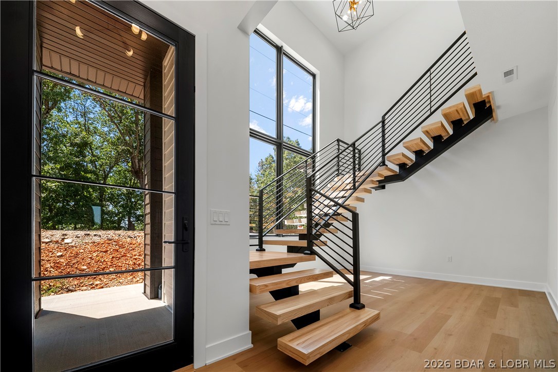 222 Red Bud Road Lake Ozark, MO 65049 - Photo 6 of 64 Dramatic floating staircase creates an unforgettab