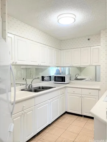 a view of a chandelier in an empty room with a window