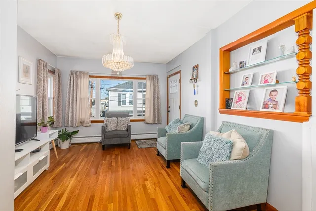 a living room with patio furniture and a chandelier