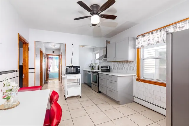 a kitchen with granite countertop stainless steel appliances a sink cabinets and a window