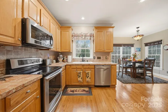 a kitchen with a stove a sink and a microwave