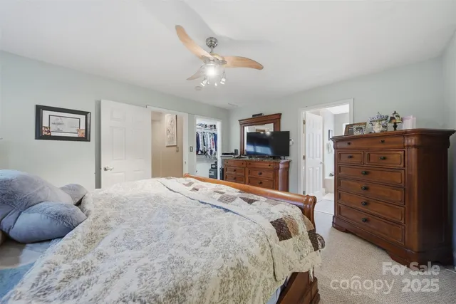 a bedroom with a bed and a television