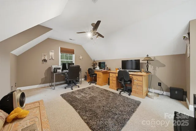 a room with gym equipment and wooden floor