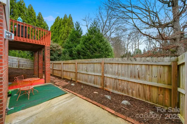 a view of backyard with deck and a garden