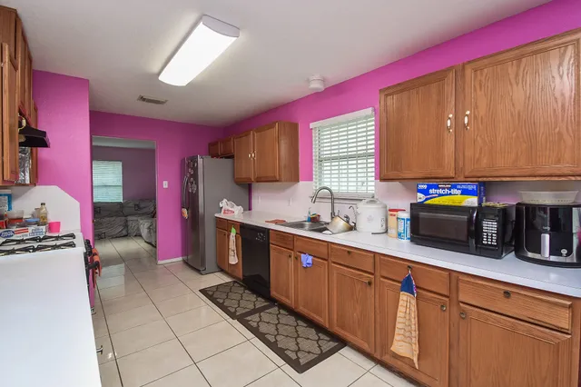 a kitchen with stainless steel appliances a sink dishwasher stove top oven and cabinets