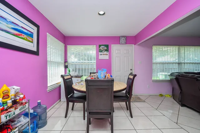 a dining room with furniture and window