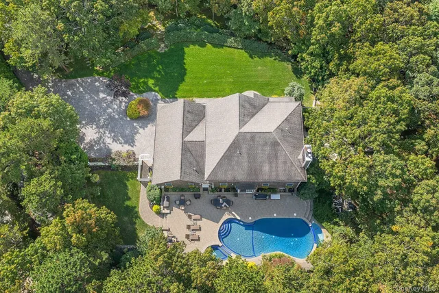 an aerial view of a house with outdoor space pool seating area and yard