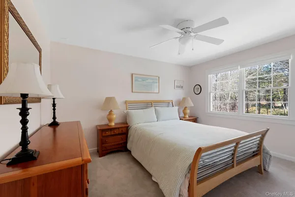 a bed room with a bed and a painting on the wall