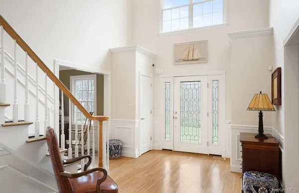 a view of an entryway with wooden floor and door