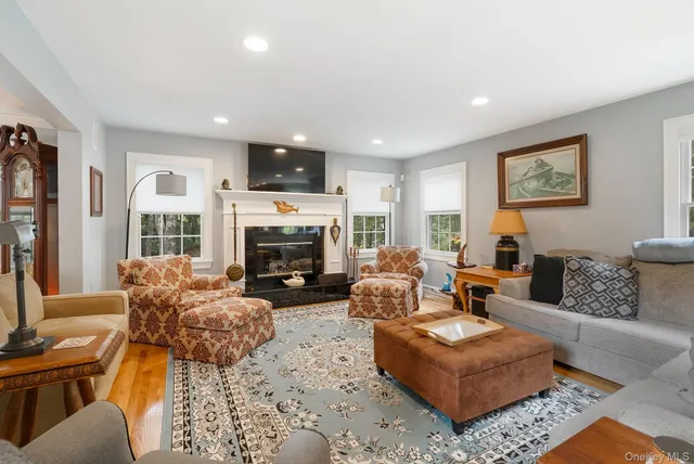 a living room with furniture large window and a fireplace