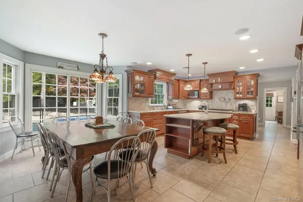 a kitchen with stainless steel appliances granite countertop a sink a stove and a refrigerator