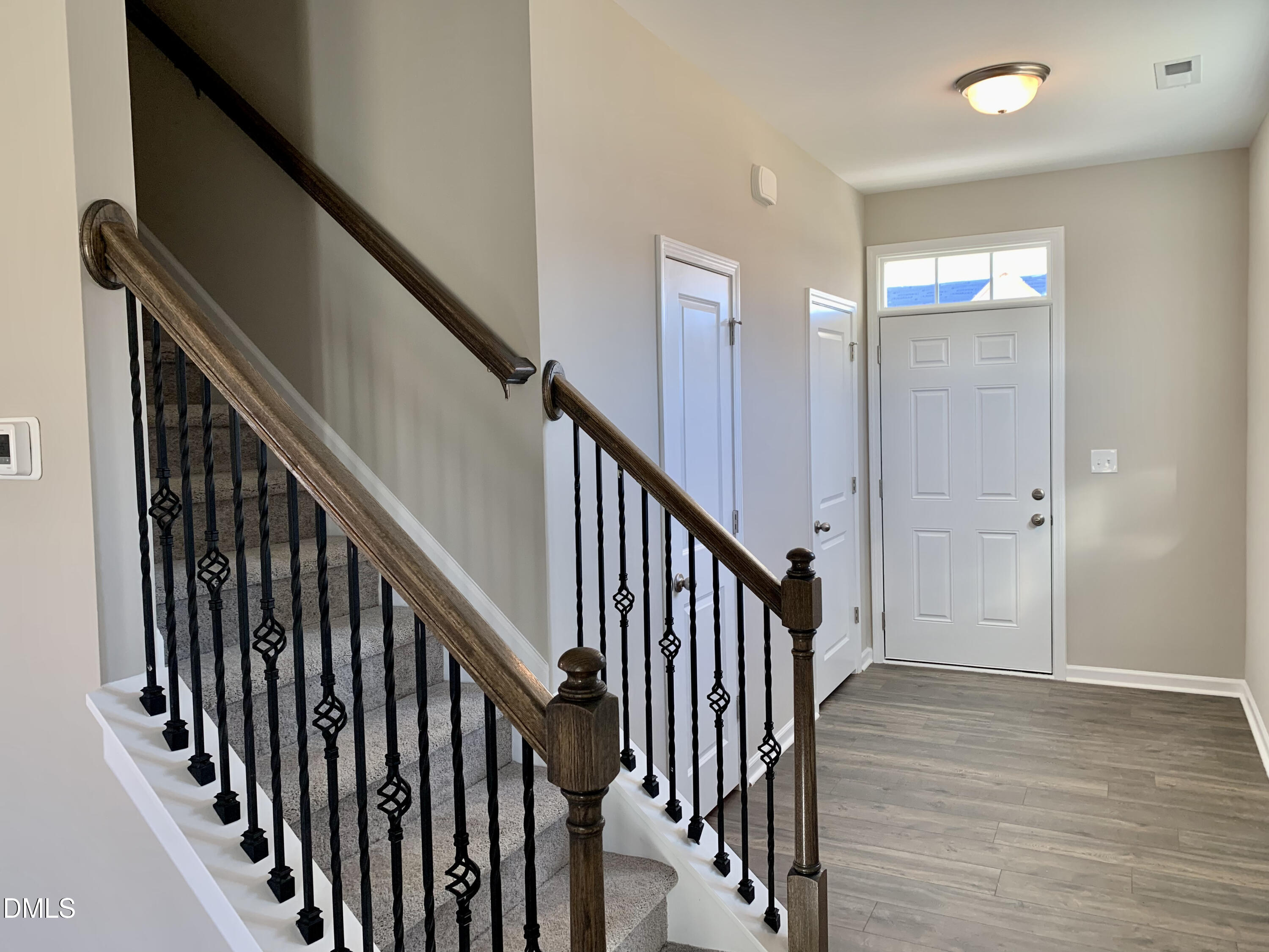 48 Weathervane Dr. Zebulon, NC 27597 - Photo 2 of 24 a view of staircase with railing and white walls
