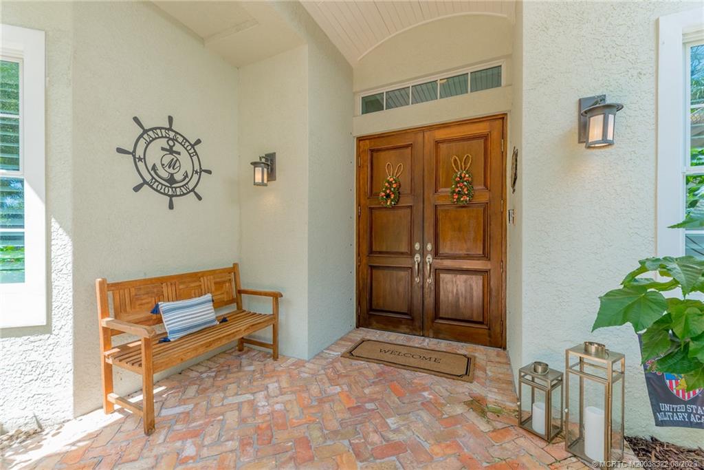 1455 Southeast Riverside Drive Stuart, FL 34996 - Photo 41 of 100 Herringbone Chicago Brick Pattern walkway leads to double 6-panel solid wood Front Door
