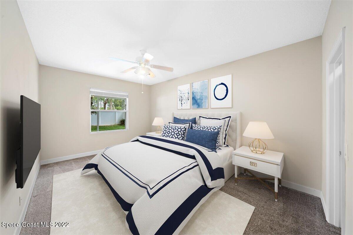 320 Pebble Hill Way Rockledge, FL 32955 - Photo 11 of 27 a bedroom with a bed and a flat screen tv