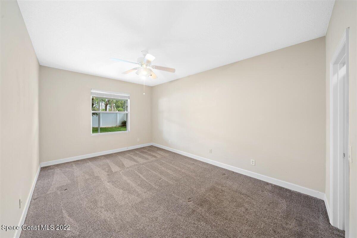 320 Pebble Hill Way Rockledge, FL 32955 - Photo 12 of 27 an empty room with windows and fan