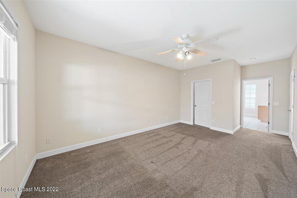 320 Pebble Hill Way Rockledge, FL 32955 - Photo 13 of 27 an empty room with a window and a ceiling fan