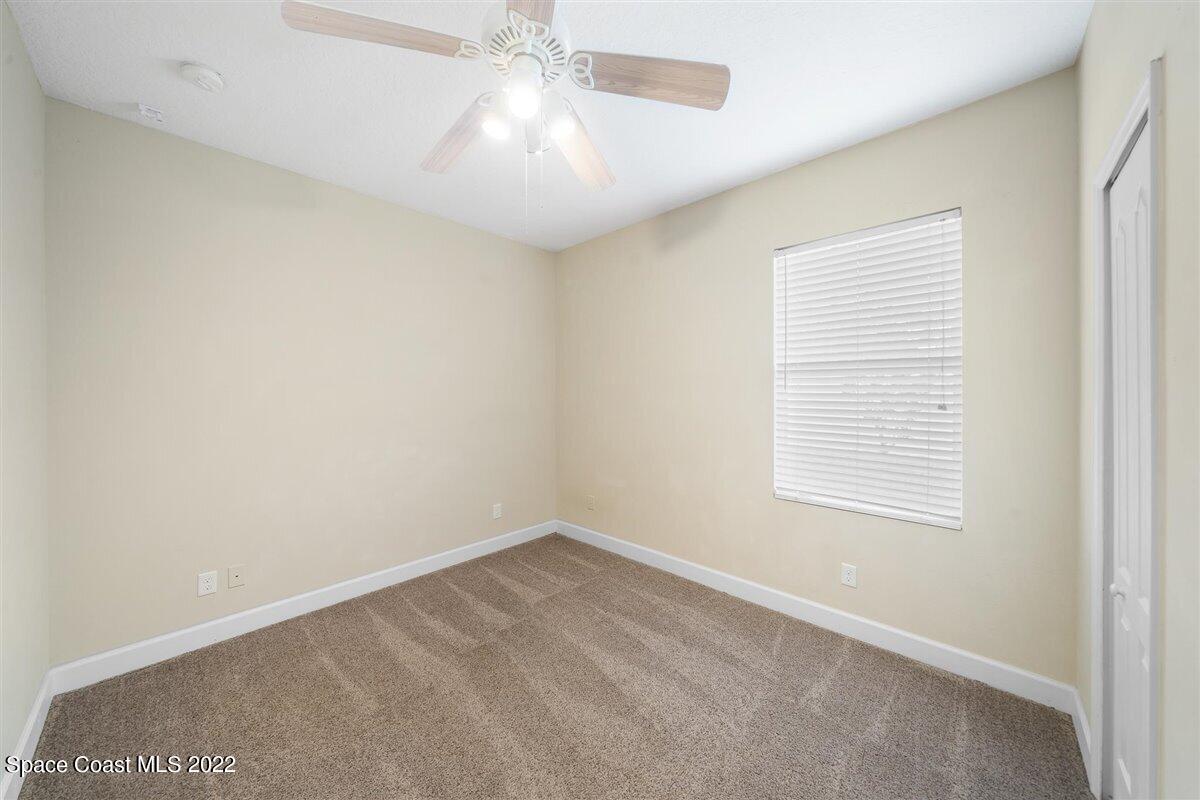 320 Pebble Hill Way Rockledge, FL 32955 - Photo 16 of 27 an empty room with a window and a fan