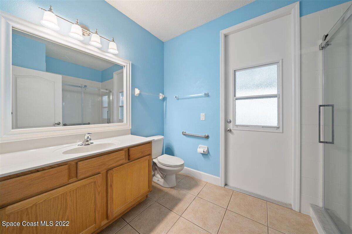 320 Pebble Hill Way Rockledge, FL 32955 - Photo 17 of 27 a bathroom with a double vanity sink a toilet and a mirror