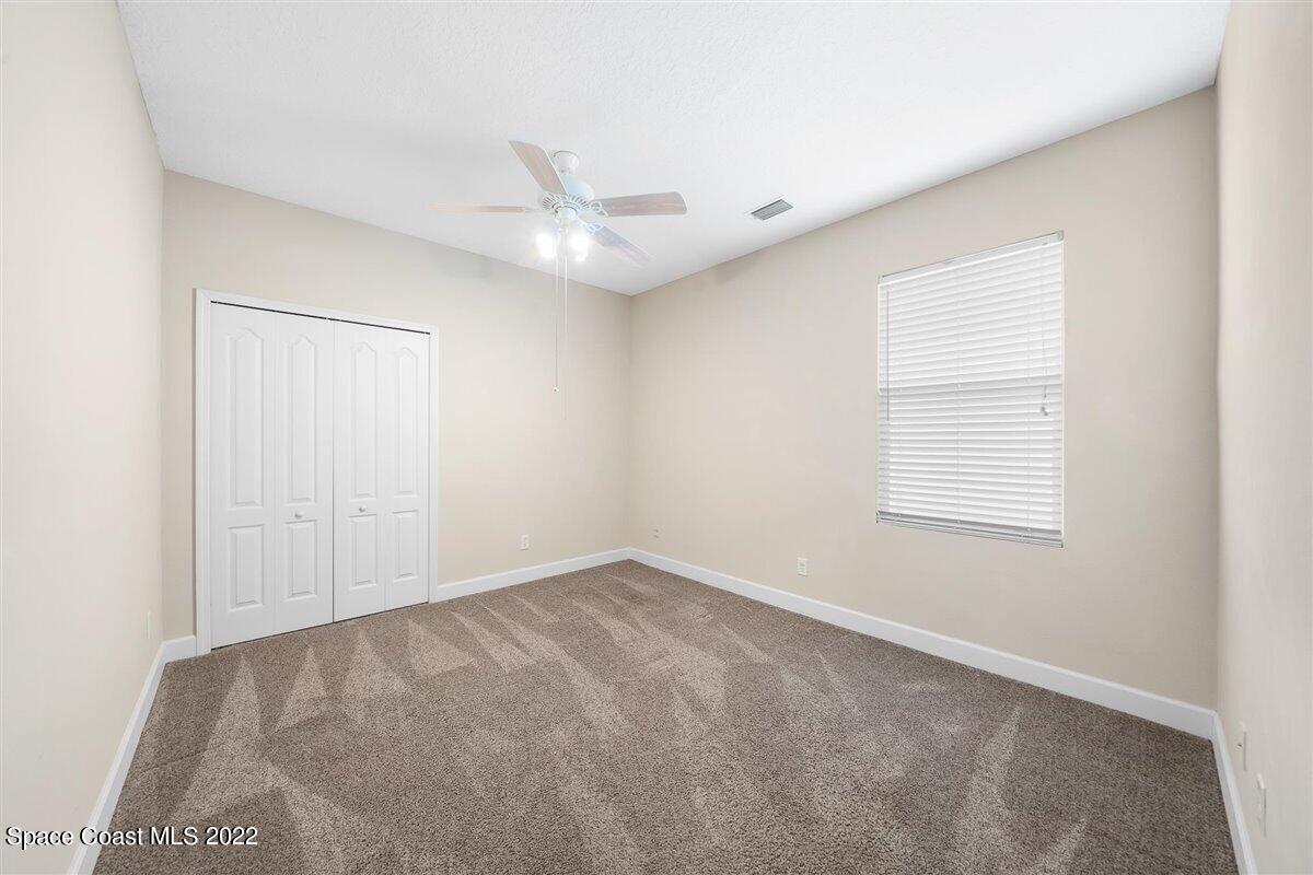 320 Pebble Hill Way Rockledge, FL 32955 - Photo 18 of 27 an empty room with a ceiling fan and a window