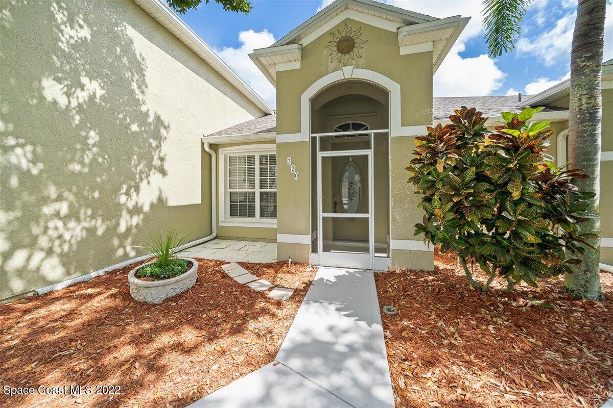 320 Pebble Hill Way Rockledge, FL 32955 - Photo 2 of 27 a front view of a house with a yard