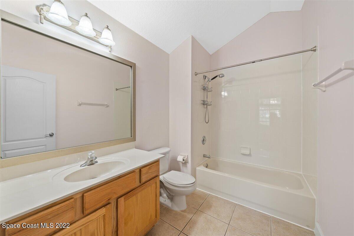 320 Pebble Hill Way Rockledge, FL 32955 - Photo 23 of 27 a bathroom with a granite countertop sink a toilet and shower